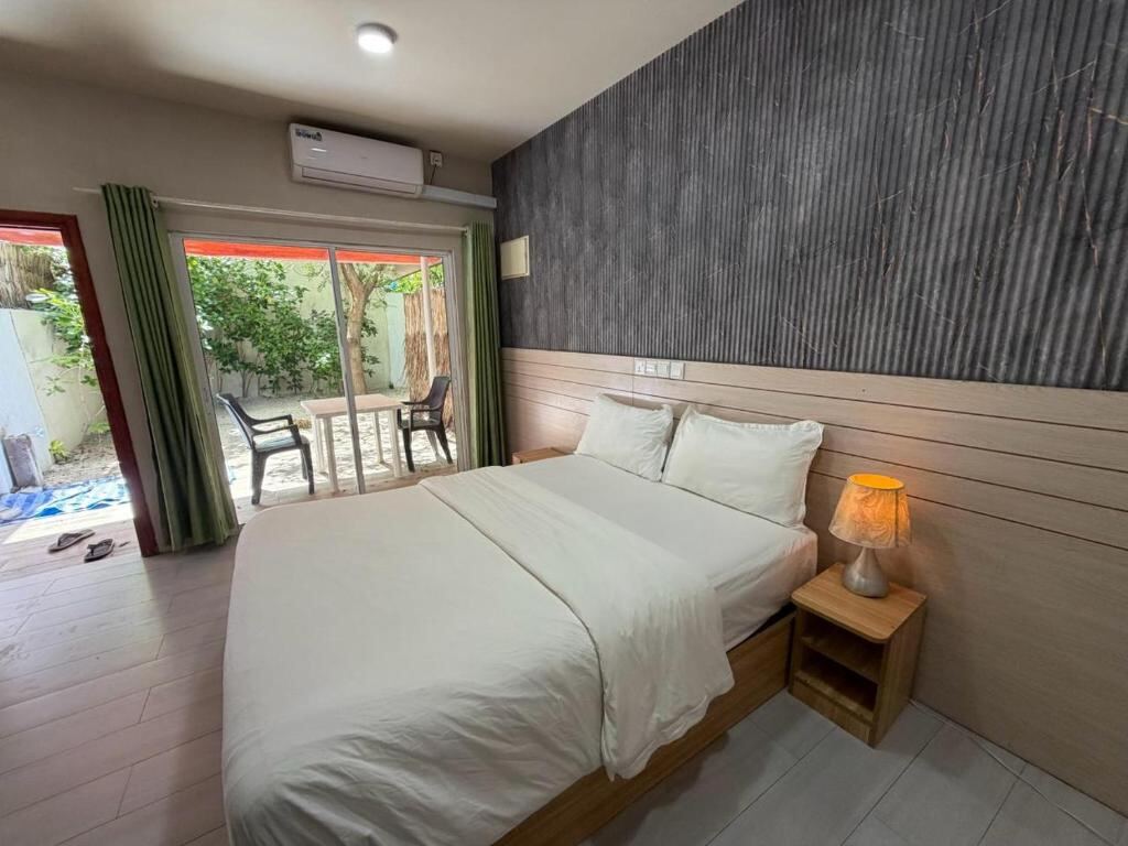 Triple room with garden view and sliding doors to the terrace