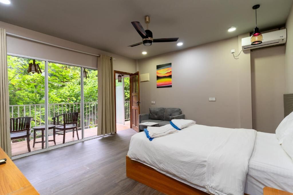 Guest room with balcony doors opening to the garden